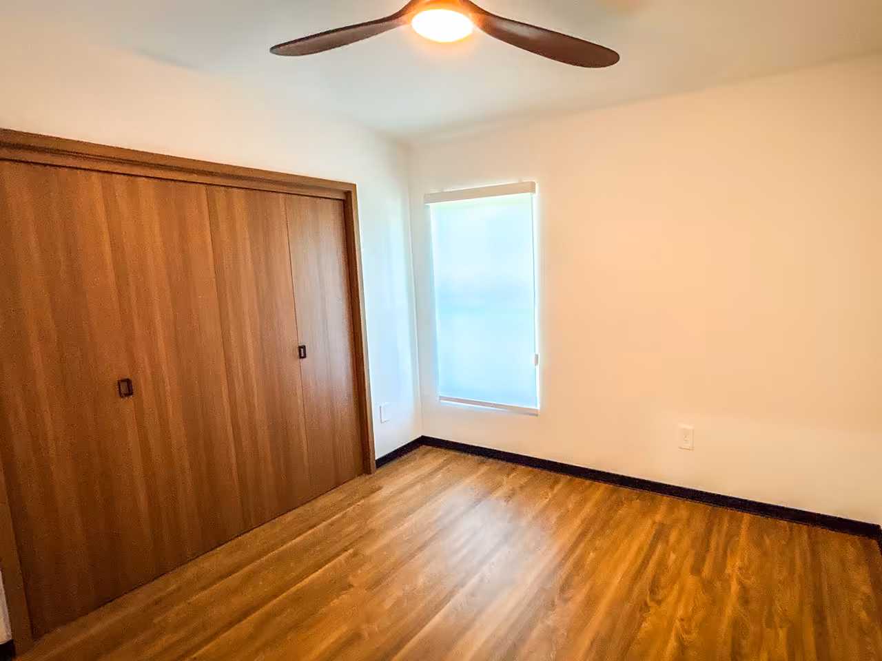 Bedroom addition with new hardwood flooring and built-in closet